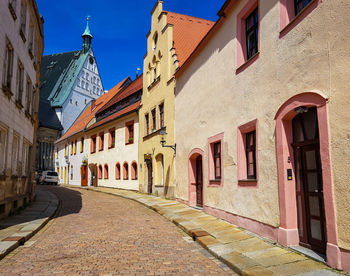 Street amidst historic buildings and church in old town