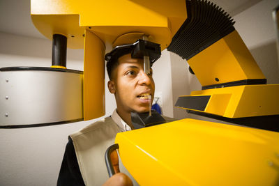 Close-up of young man using machinery