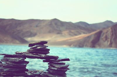 Close-up of sea against mountain