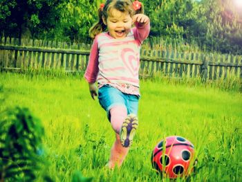 Portrait of smiling girl on grassy field