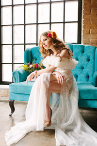 Redhead bride in dress holding wedding bouquet and smiling. wedding day concept