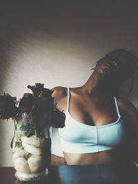 Close-up of young woman with drink on table