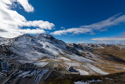 Scenic view of snowcapped mountains against blue sky