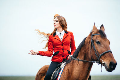 Young woman with horse riding