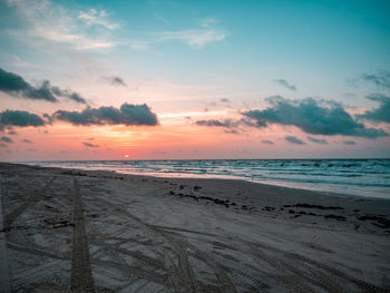 Scenic view of beach against sky during sunset