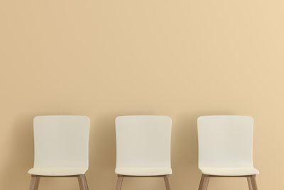 Empty chairs against wall