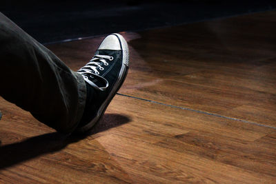 Low section of shoes on hardwood floor