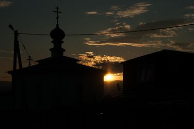 Silhouette of bell tower against sky during sunset