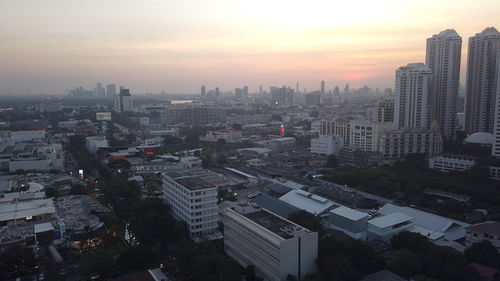 High angle view of buildings in city against sky during sunset