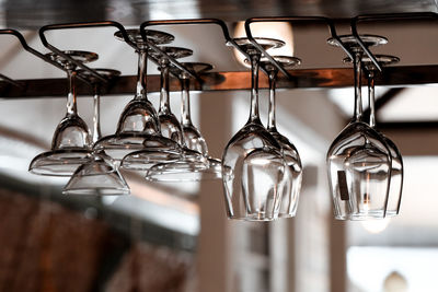 Close-up of drinking glasses hanging in row