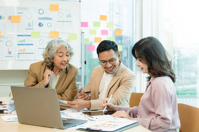 Group of asian business working together in a modern office.