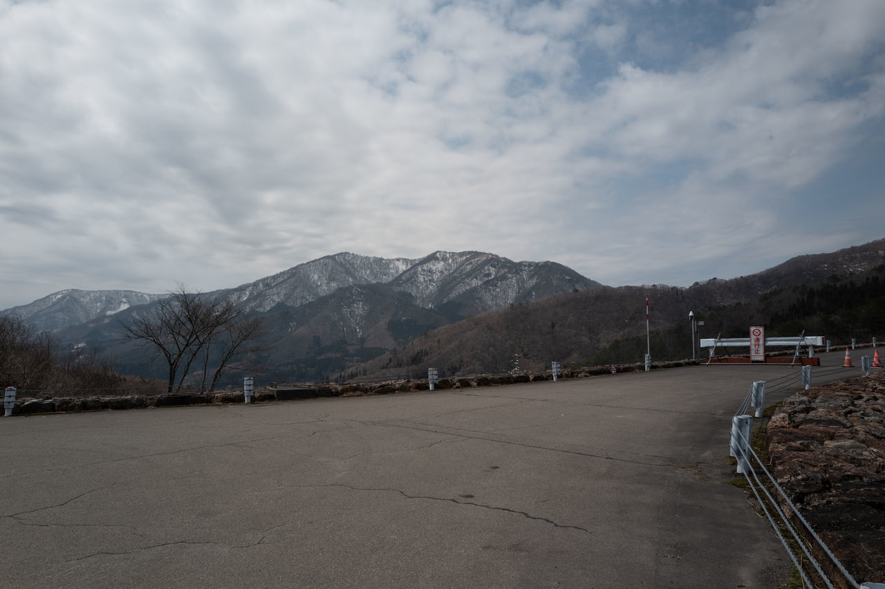 mountain, sky, cloud, snow, mountain range, road, transportation, environment, nature, scenics - nature, landscape, no people, beauty in nature, day, winter, travel, travel destinations, outdoors, cold temperature, architecture, city