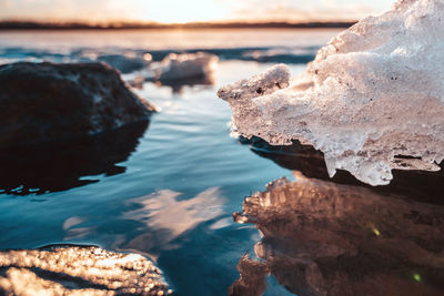 Rocks in sea against sky