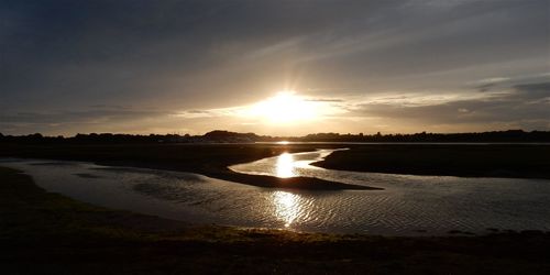 Scenic view of lake against sky during sunset