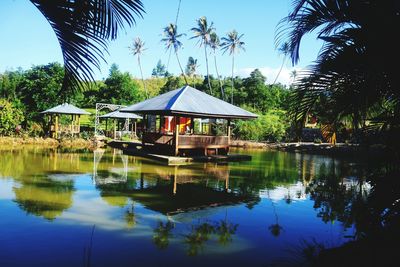 Gazebo by lake against sky