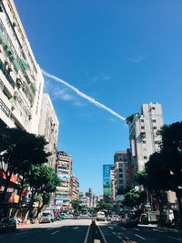 City street and buildings against blue sky