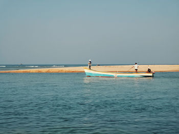 View of boat in sea against clear sky