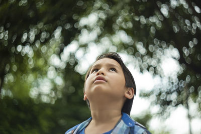 Low angle view of boy looking up