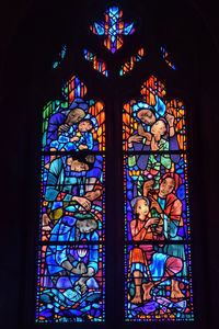 Low angle view of multi colored glass window in building