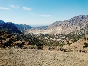 Scenic view of dramatic landscape against blue sky