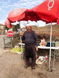 Portrait of man standing on street market