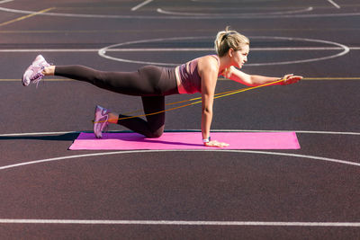 Full length of senior woman with arms raised