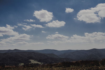 Scenic view of landscape against cloudy sky