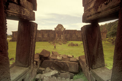 Old ruins on field against sky