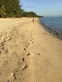 Man walking on sandy beach