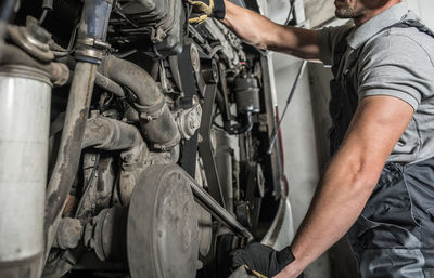 Midsection of man working in workshop