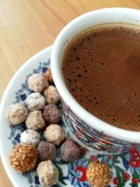 High angle view of coffee and cookies on table