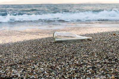 View of paper in bottle on beach