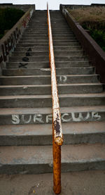 Close-up of rusty railing on steps