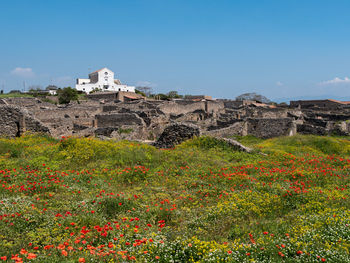 Scenic view of old building against clear blue sky