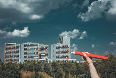 Low angle view of skyscraper against cloudy sky