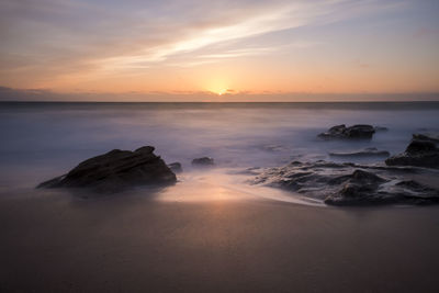 Scenic view of sea against sky during sunset