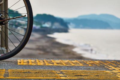 Close-up of bicycle and scenic beach