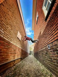 Low angle view of alley amidst buildings