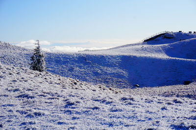 Scenic view of snow covered mountains against sky