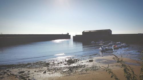 Scenic view of sea against clear sky at sunset