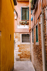 Narrow alley amidst buildings in town