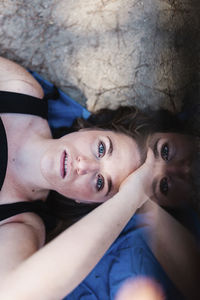 High angle portrait of smiling woman lying down