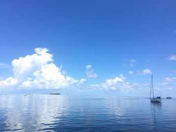 Sailboats in sea against sky