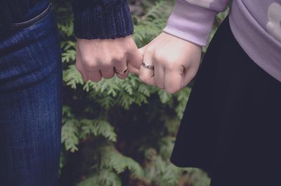 Close-up of couple holding hands