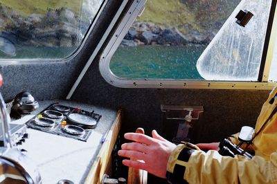 Close-up of hand on boat in sea