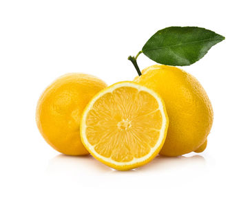 Close-up of orange fruit against white background