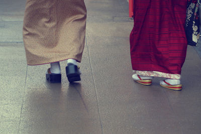 Low section of woman standing on tiled floor