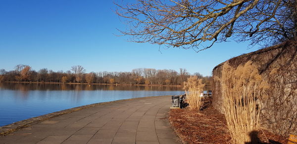 Scenic view of lake against clear blue sky