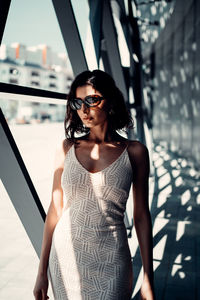 Young woman wearing sunglasses standing outdoors