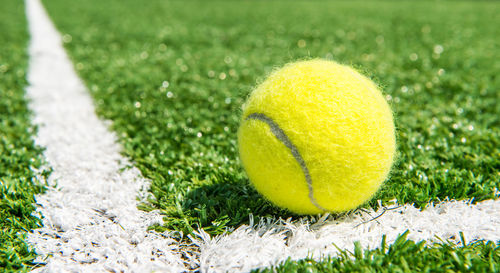Close-up of tennis ball on field